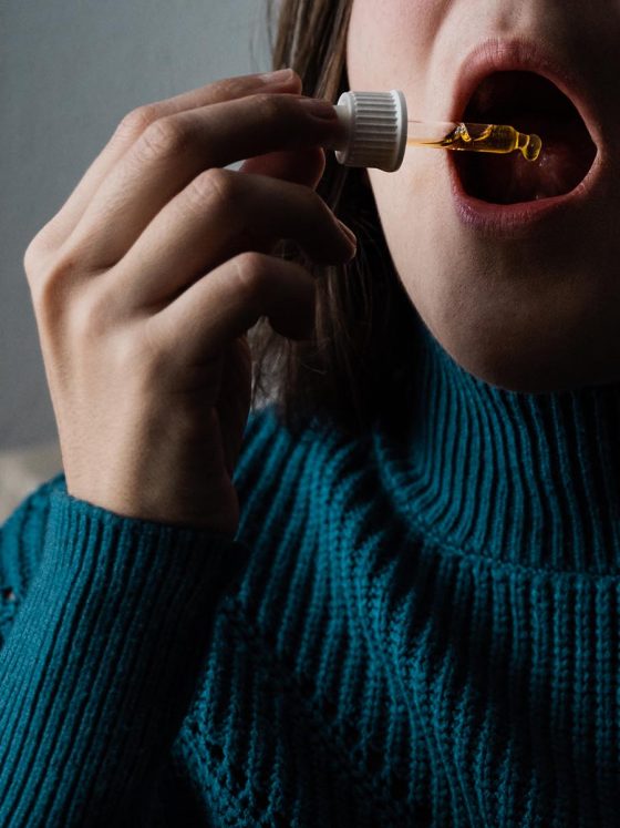 woman taking cbd oil