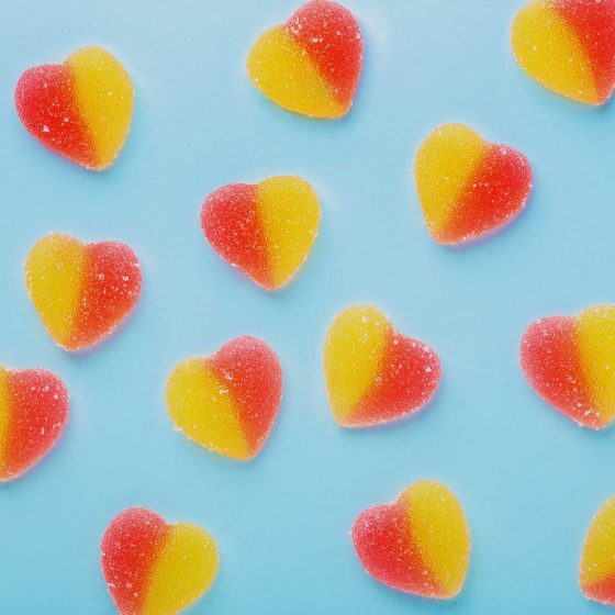heart shaped cannabis gummies on bluebackground