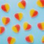 heart shaped cannabis gummies on bluebackground