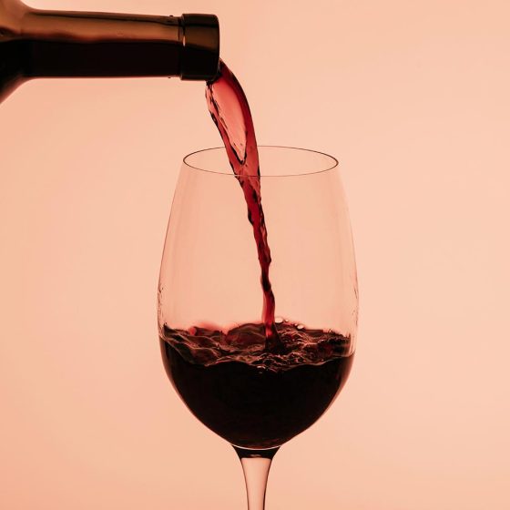 red wine pouring into glass