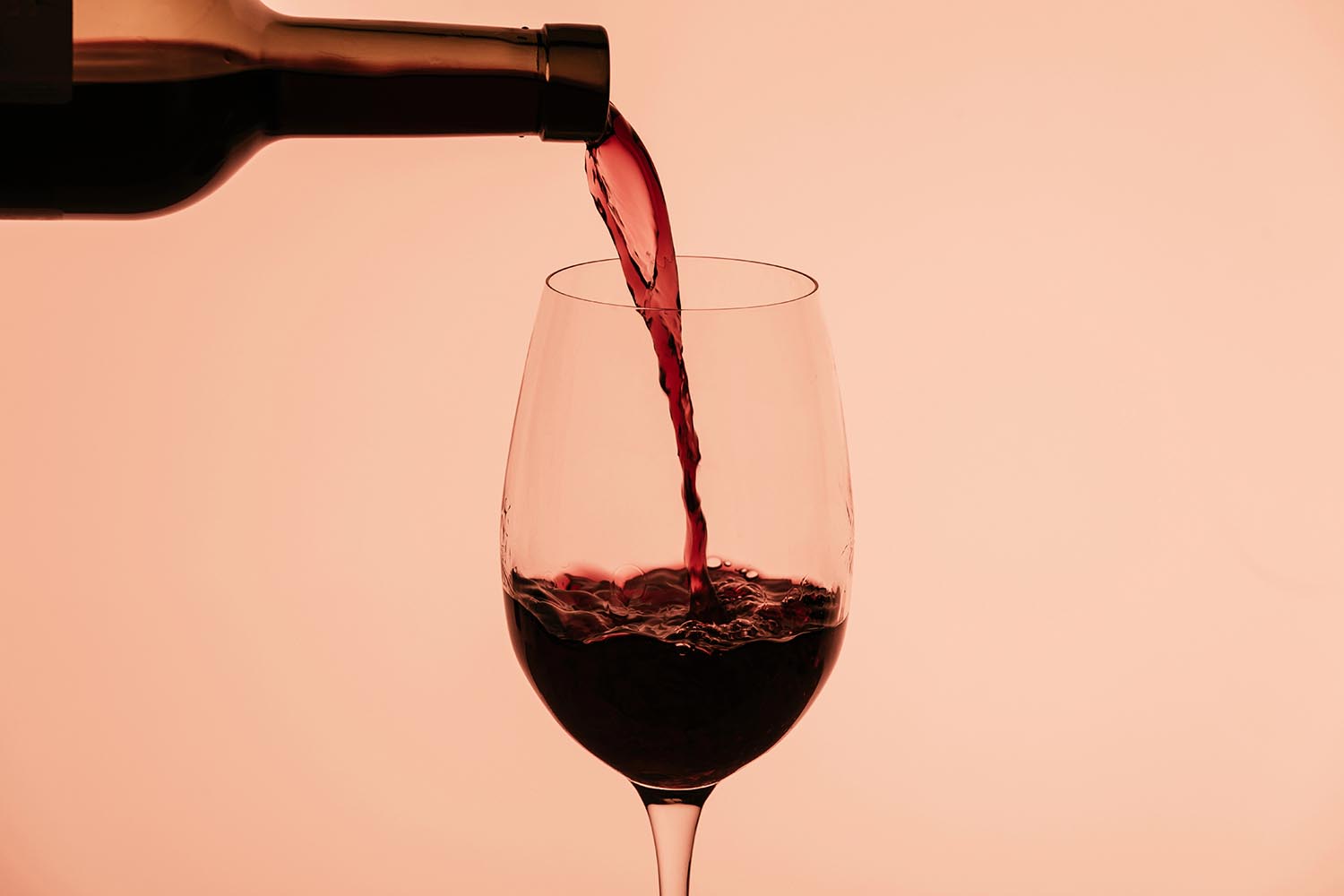 red wine pouring into glass